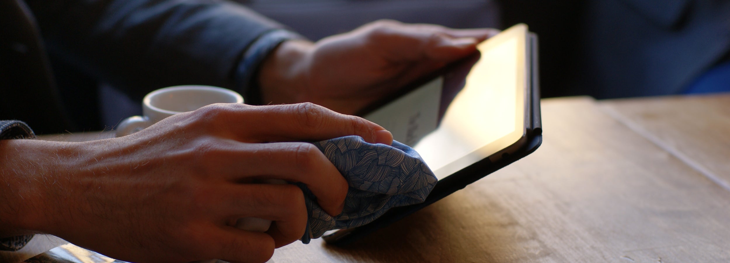 Gentleman wiping his Ipad with a FatCloth multipurpose pocket square